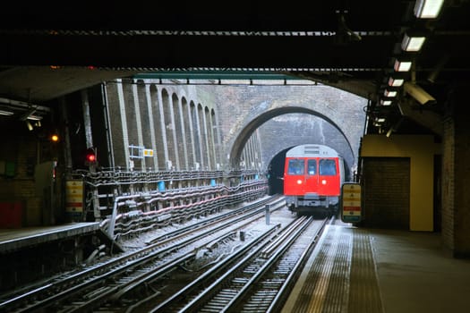Red Train coming to Station London England UK