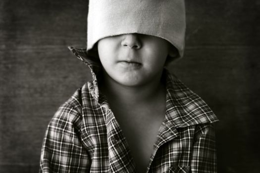 portrait of a boy wearing a hat with eyes closed