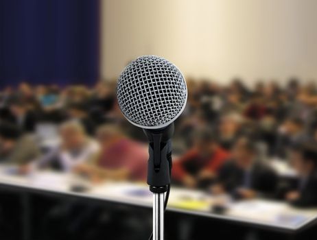People attending seminar with microphone facing the speaker