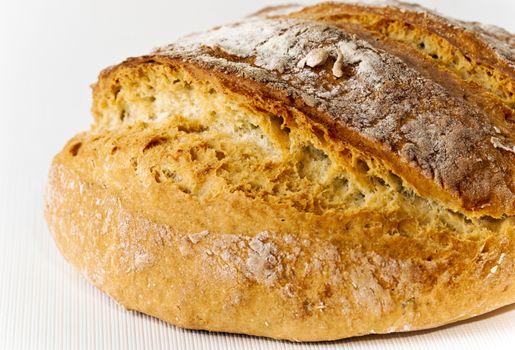 Honey white bread with poolish on white background close up