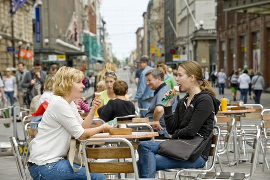 Couple eats ice cream in street cafe Helsinki, Finland