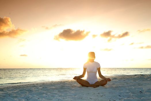 sunset yoga woman on sea coast