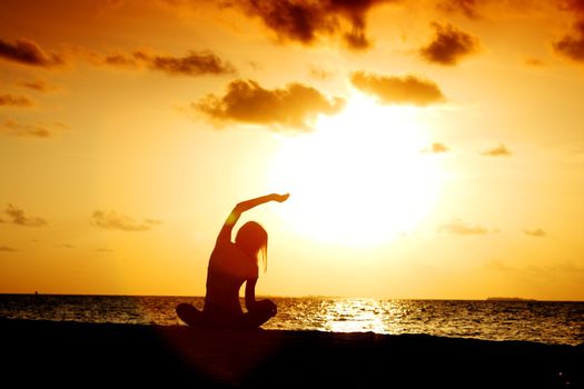 sunset yoga woman on sea coast