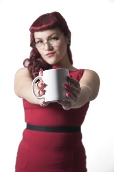 Coffee cup held up with out of focus red headed sexy business woman in the background. Isolated on white background