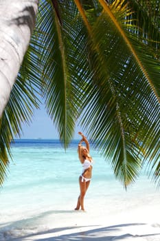 woman under palm sea on backgroud