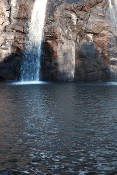 Waterfall in the rock. Vertical photo