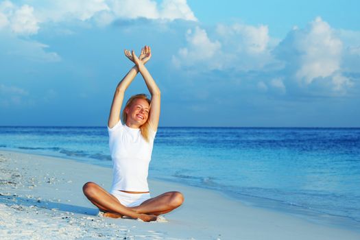 yoga woman on sea coast