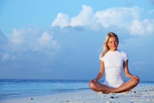 yoga woman on sea coast