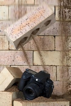 A falling brick is about to demolish a camera.