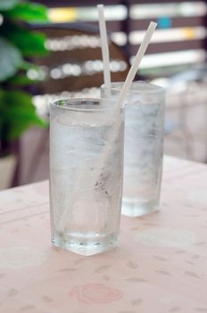 two glass of water with ice on table in restaurant