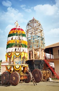 Traditional holly chariot with wooden wheels in the Indian religious temple. Preparation for Vishnu festival. India, Goa