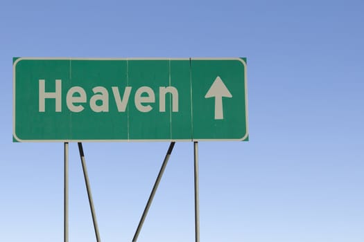 Green road sign with a blue sky gradient background.