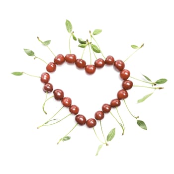 The heart shape from cherries with green leaves