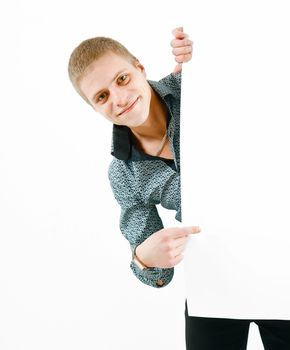 young smiling man looks out a white stand