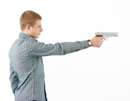 a man with a gun aiming at the distance. profile