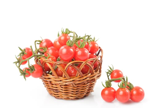 Cherry tomatoes on twigs in the basket
