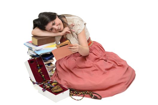 a girl surrounded by books, jewelry and letters