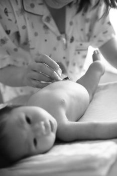 Baby lying on the table to be prepared to clean.