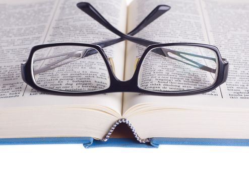 Reading glasses with books isolated on the white