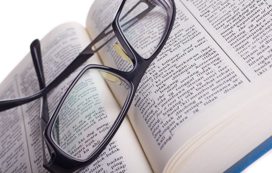 Reading glasses with books isolated on the white