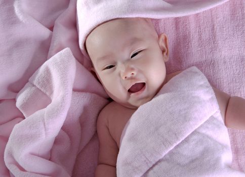 Baby after bath. Cheerful child.