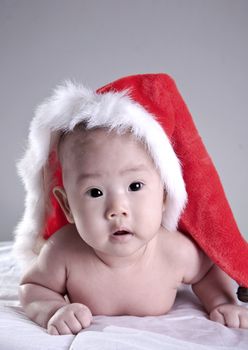 portrait of sweet baby in christmas hat