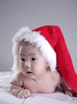 portrait of sweet baby in christmas hat