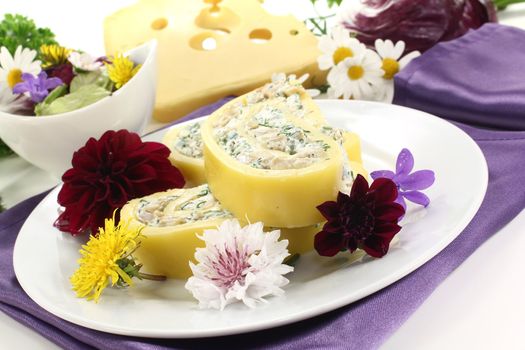 Cheese rolls with wild herb salad, bread and fresh edible flowers