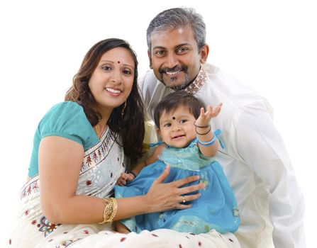 Traditional Indian family with one child sitting on white background