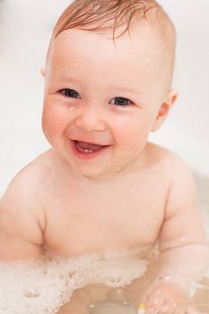 Adorable bath baby with soap suds on hair