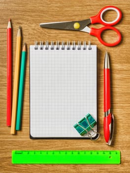 Still life of office supplies with a notebook and accessories