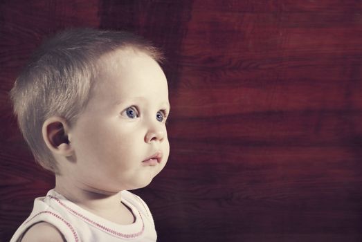 Portrait of handsome young boy on wood background.