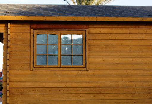 Wooden house with wall and window         