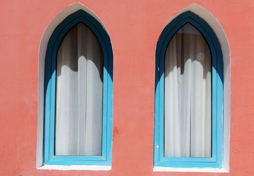 Arabic architecture: windows and bright coral wall         