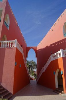Arabian architecture: red walled building and blue sky   