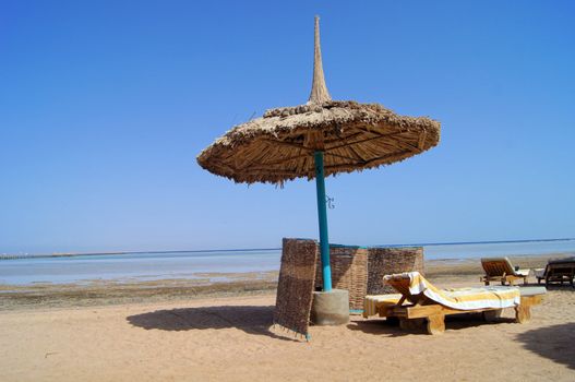 Sun beds and umbrella on the beach       