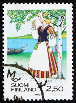 FINLAND - CIRCA 1989: a stamp printed in the Finland shows Woman from Veteli, Regional Costume, circa 1989