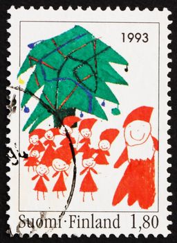 FINLAND - CIRCA 1993: a stamp printed in the Finland shows Santa and Christmas Tree, Children�s Drawing, Christmas, circa 1993