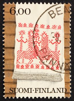 FINLAND - CIRCA 1980: a stamp printed in the Finland shows Kaspaikka Towel Design, Ritual Towel, circa 1980