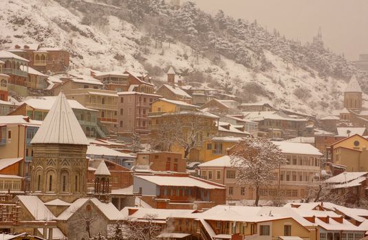 Winter view to covered with snow Tbilisi Old town in misty day