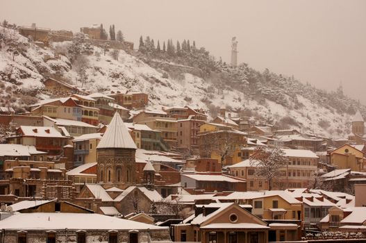 Winter view to covered with snow Tbilisi Old town in misty day