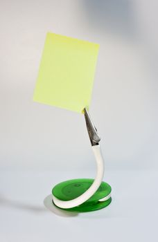 clip stand and post it note, put your message on paper