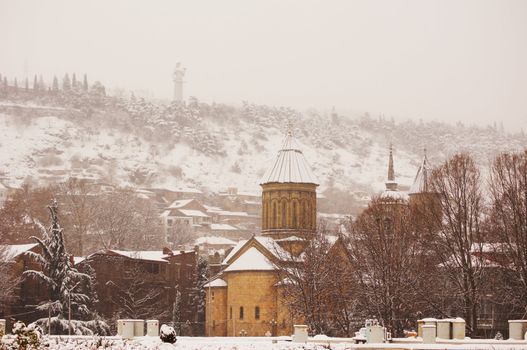 Winter view to covered with snow Tbilisi Old town in misty day