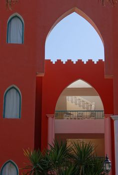 Arabic architecture: building with red and white walls     