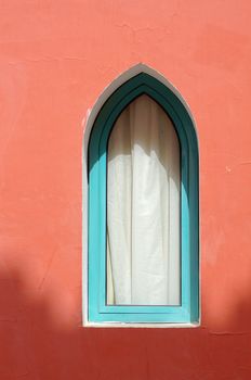 Arabic architecture: window on the red wall                