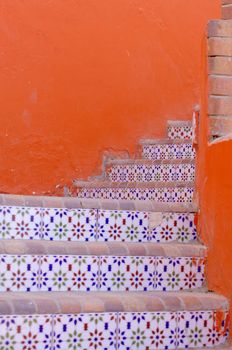 Courtyard of mediterranean villa with ceramic tile walkway and blooming bushes in Egypt             