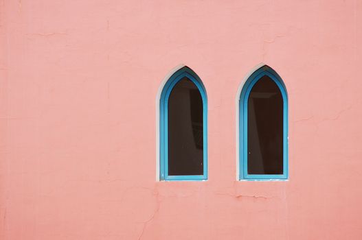 Arabic architecture: two windows on the red wall             