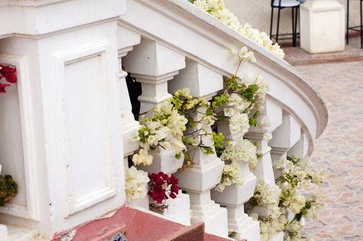 Courtyard of mediterranean villa with ceramic tile walkway and blooming bushes in Egypt      