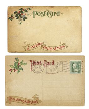 Two aging Christmas time postcards from 1910, isolated on white.  Both are blank and have clipping paths.
