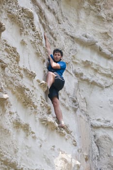 Young sportsman climbing a cliff without belay